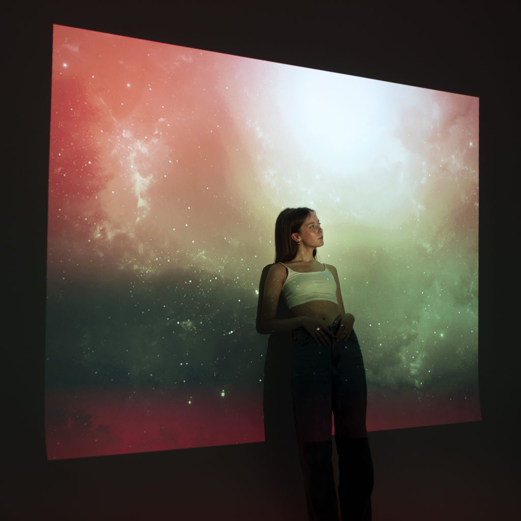 young-woman-standing-universe-texture-projection
